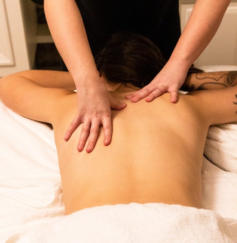 a woman getting a back massage at a spa